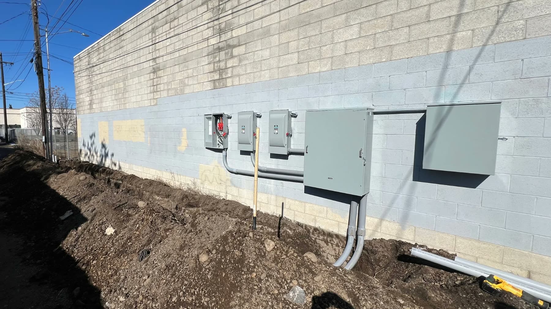 Service disconnects and conduit on a commercial building wall