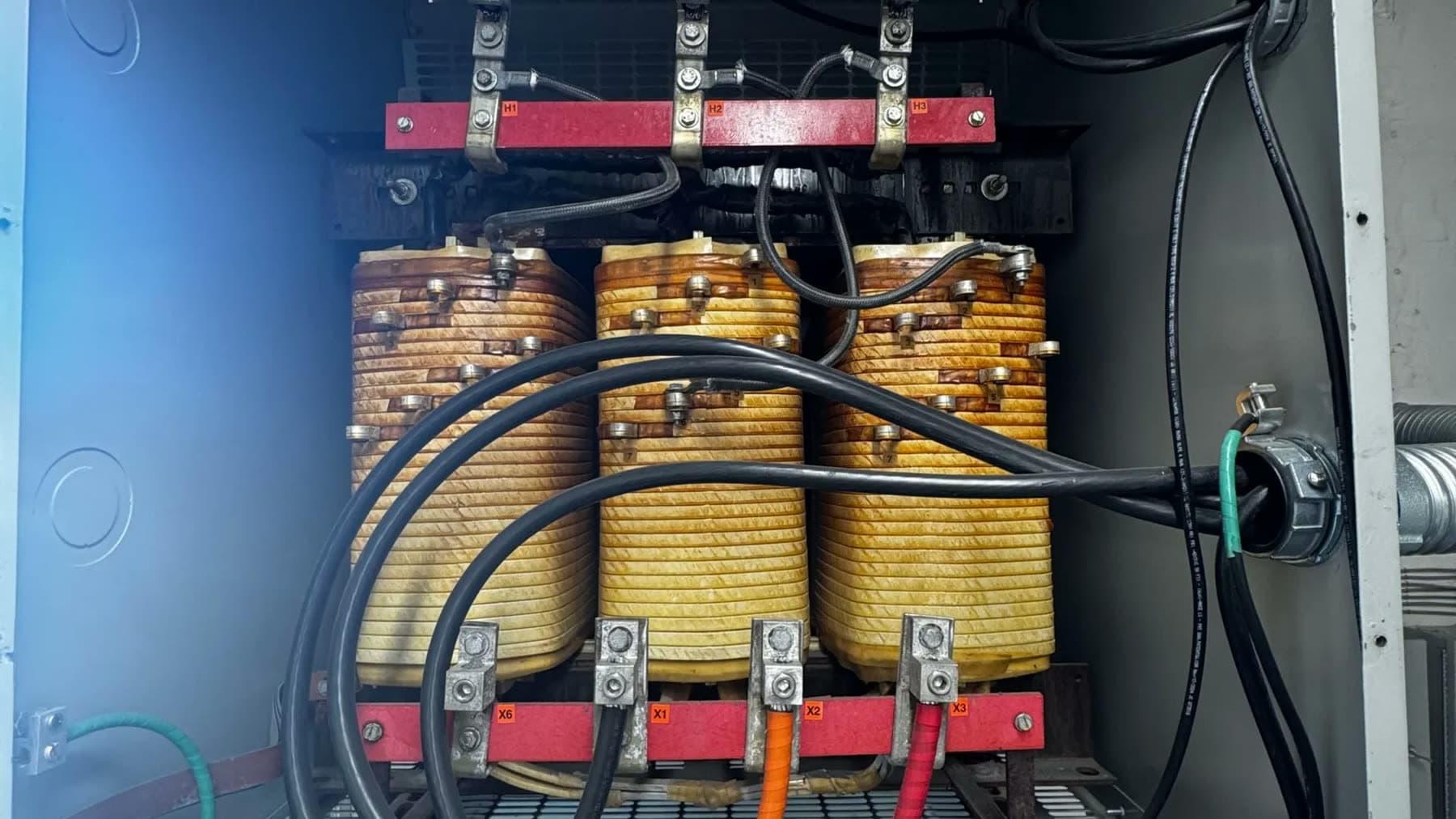 Transformer windings and busbars inside an opened electrical enclosure