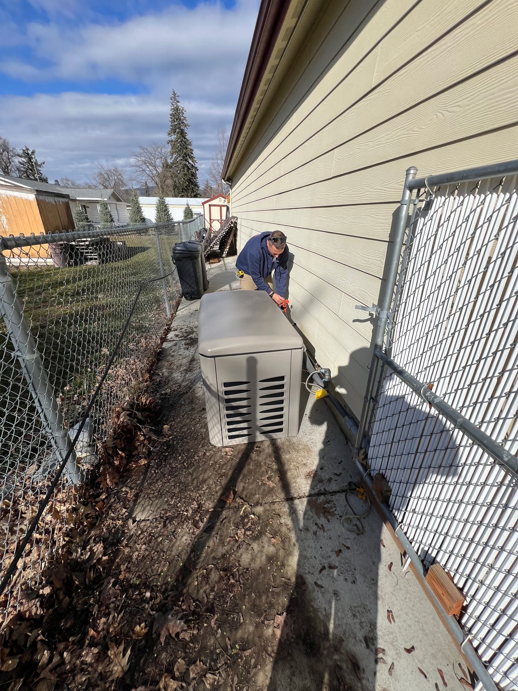 Standby generator installed beside a house