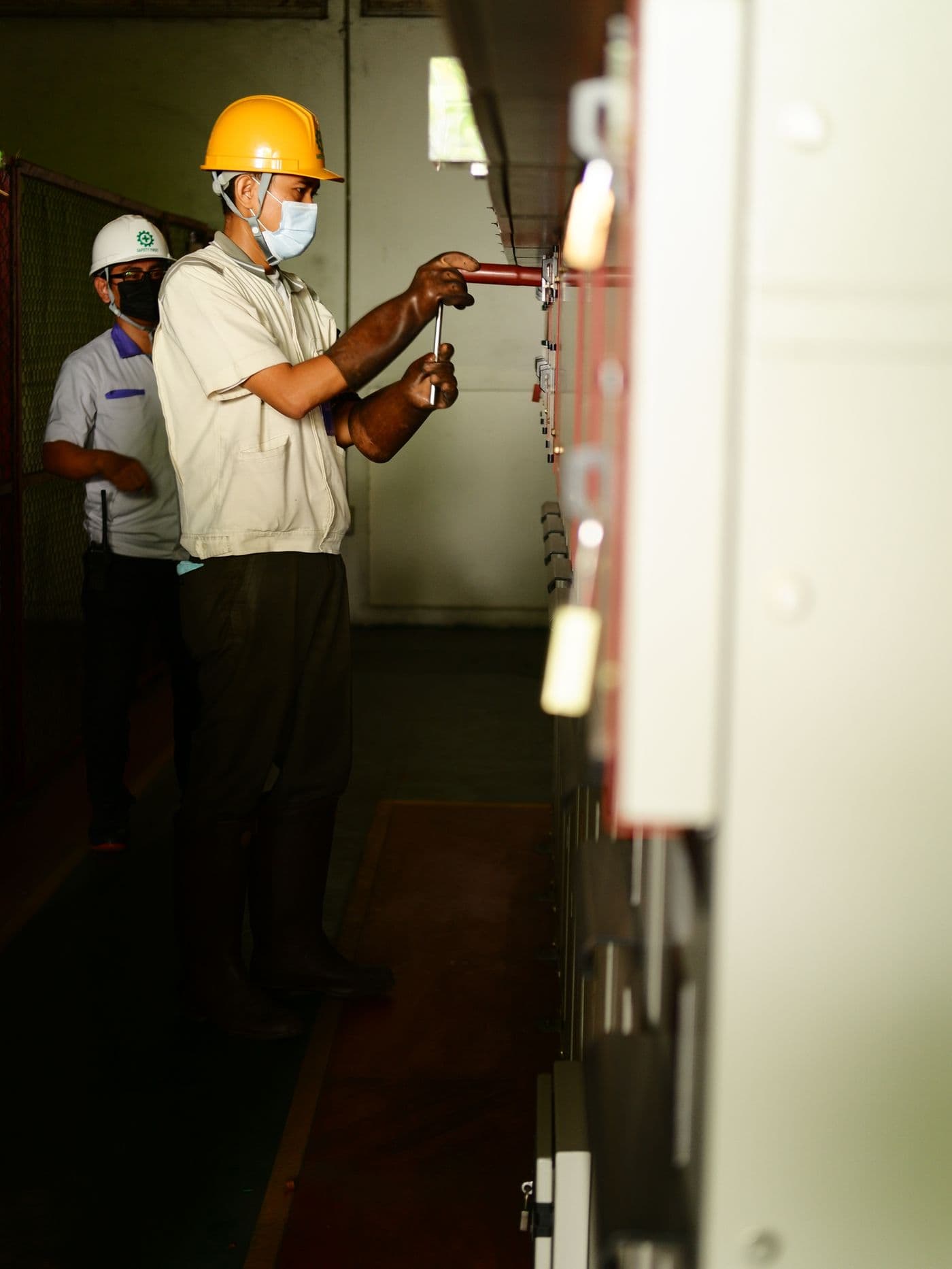 Two electricians working together on site
